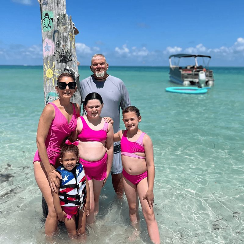 Group posing by the ocean