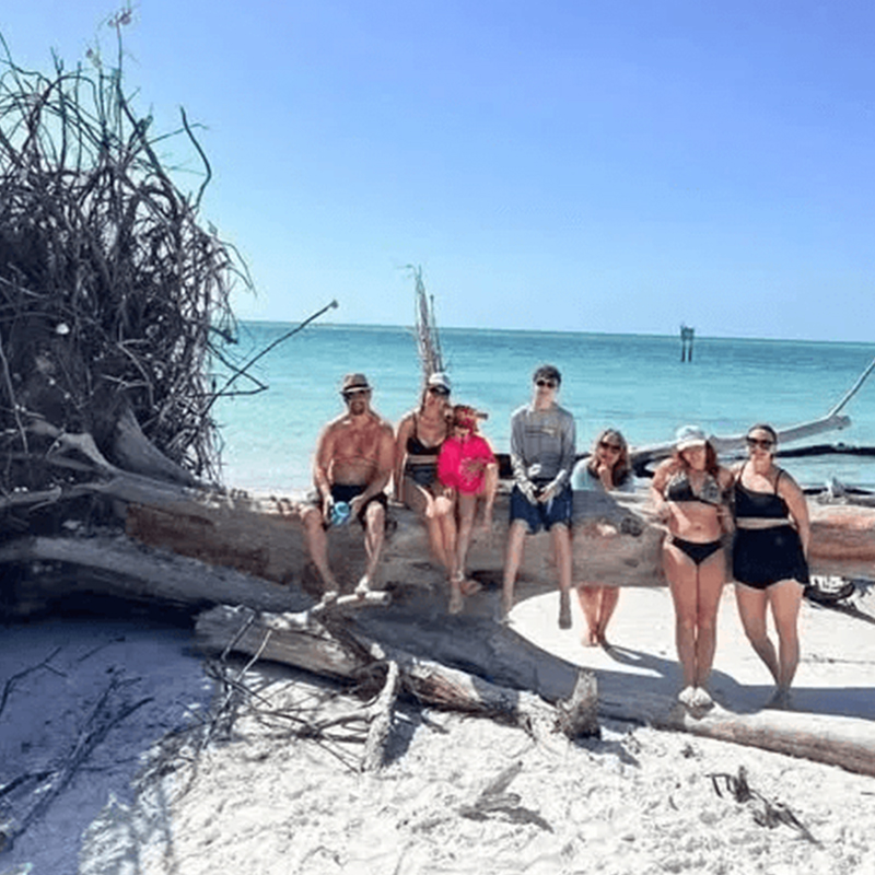 Group sitting on beach log