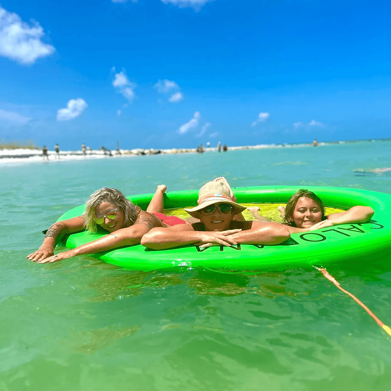 Three women floating in turquoise water