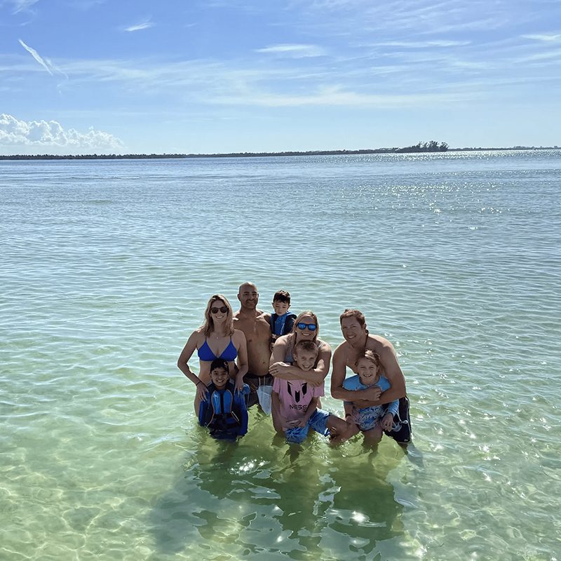 Happy family posing by the sea