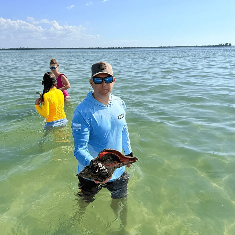 People wading in clear sea water