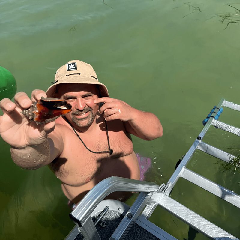 Person in hat showing sea life