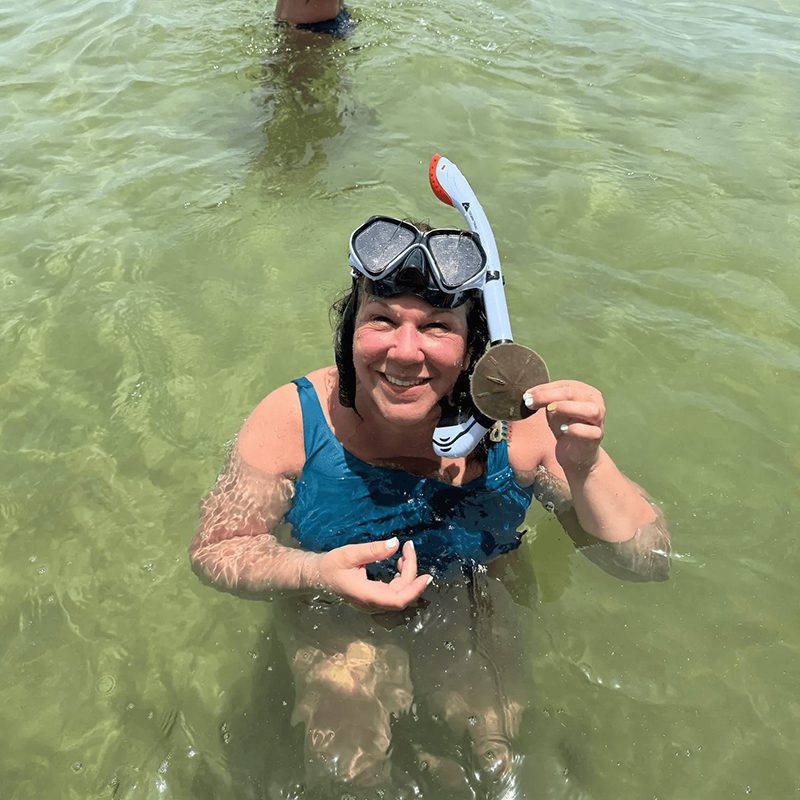 Smiling snorkeler with sea treasure