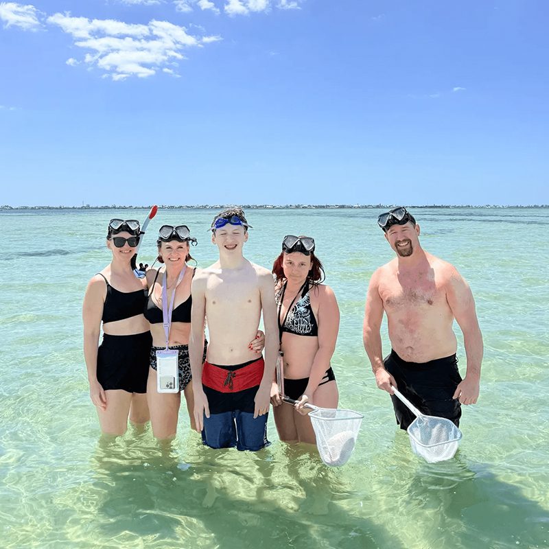 People with snorkels in shallow water