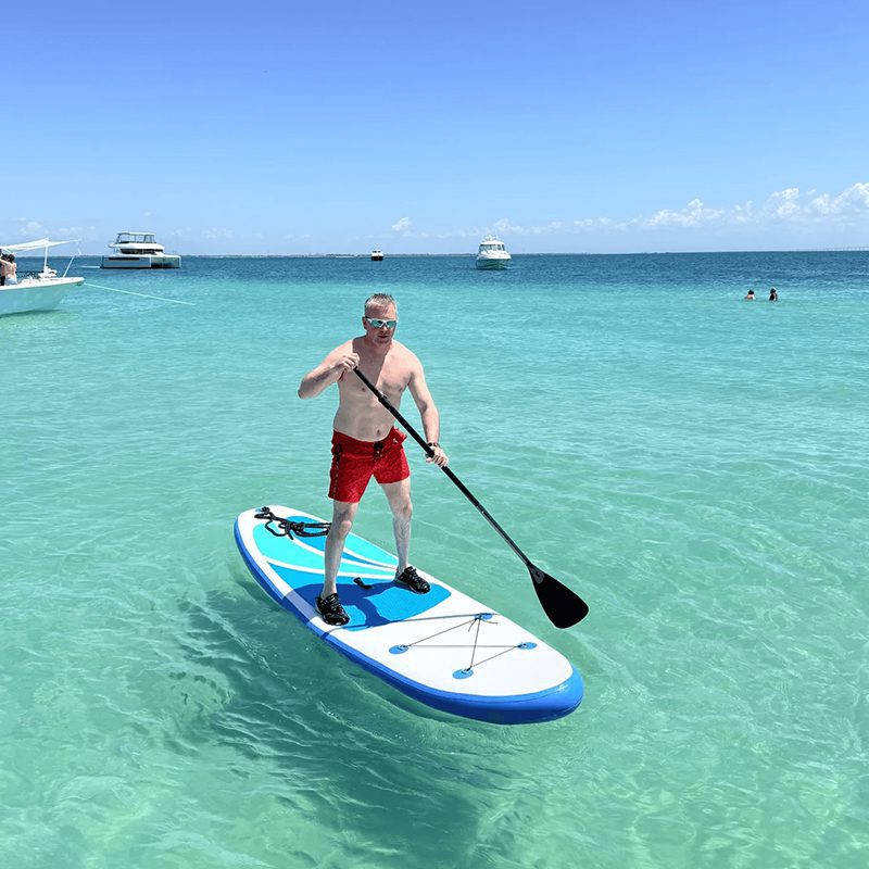 Person balancing on paddleboard in ocean