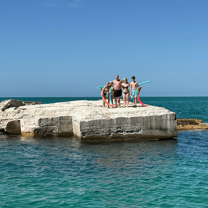 Group enjoying summer on seaside rocks
