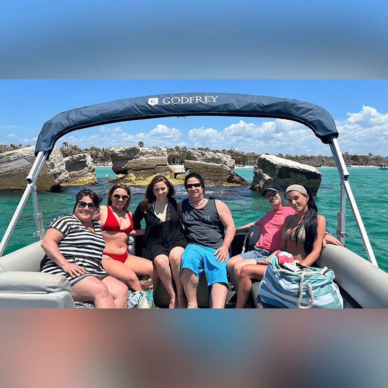 Friends enjoying sunny boating day