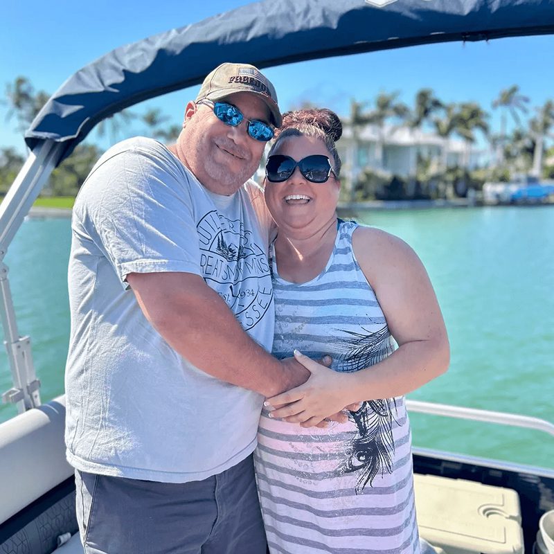 Happy pair enjoying sunny boat ride