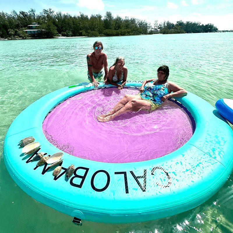 People relaxing on inflatable in the water