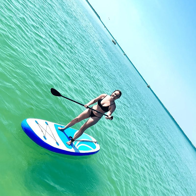 Woman enjoying paddleboarding in the ocean