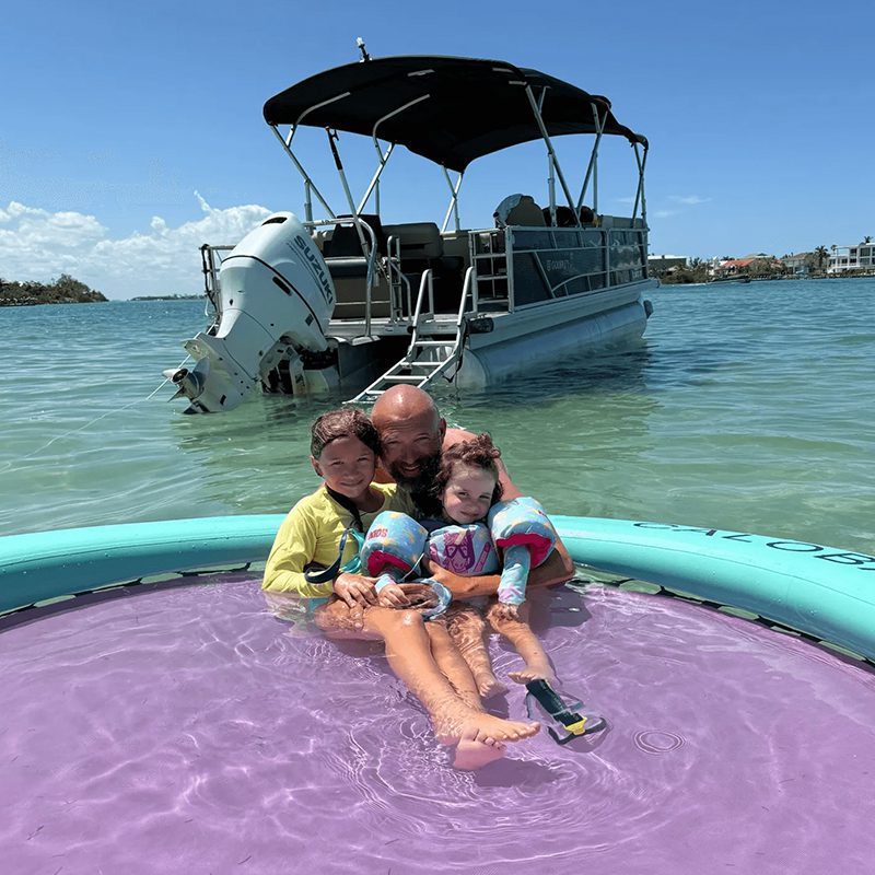 Children and adult relaxing on float