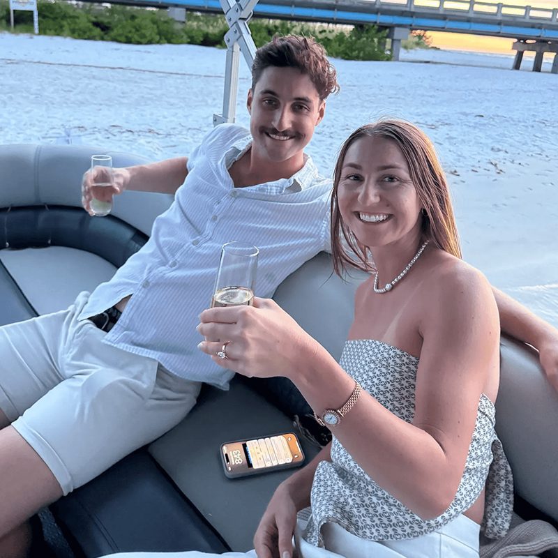 Smiling pair relaxing by the sea