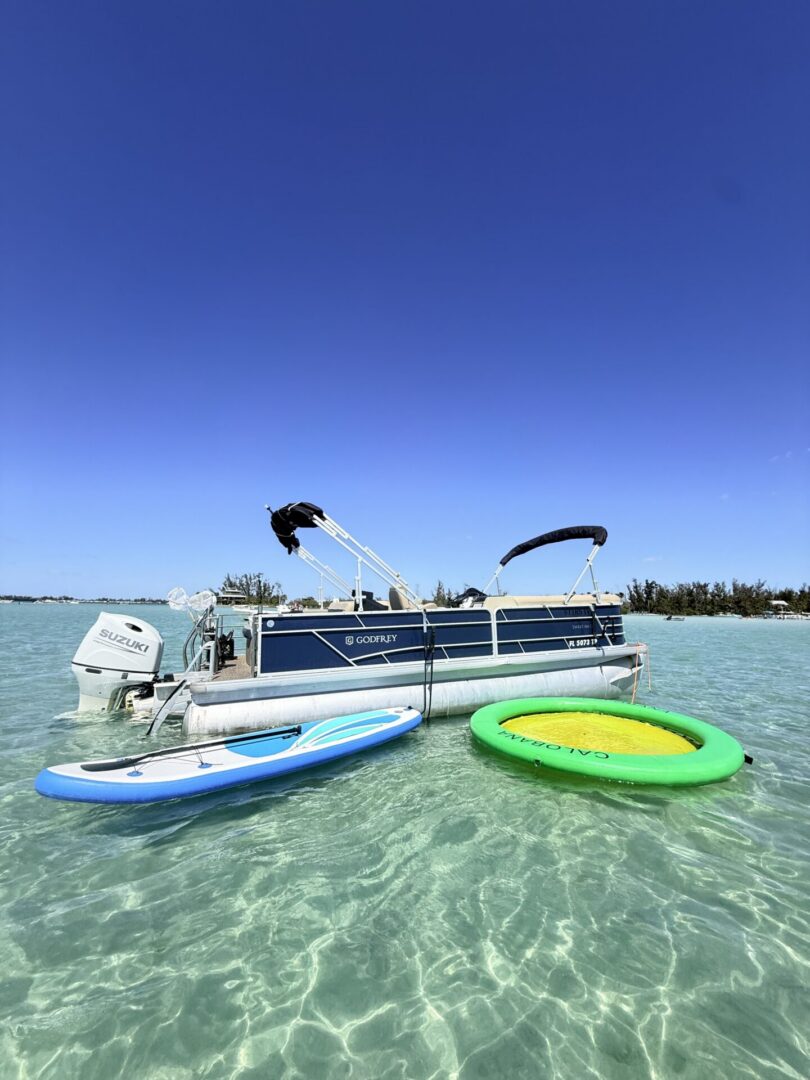 Pontoon boat with paddleboard and inflatable ring