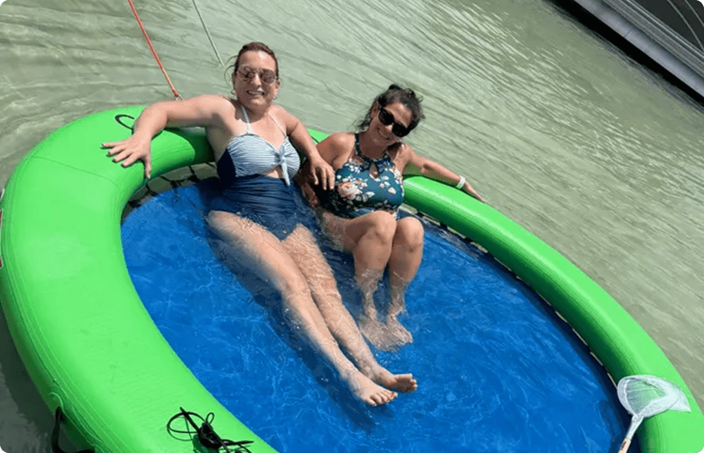 Two women relaxing on a floating pool.