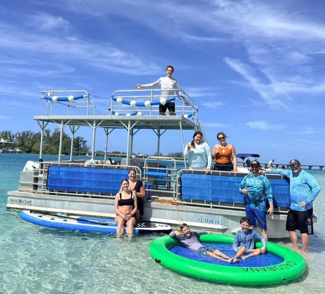 Group enjoying pontoon boat and inflatable float