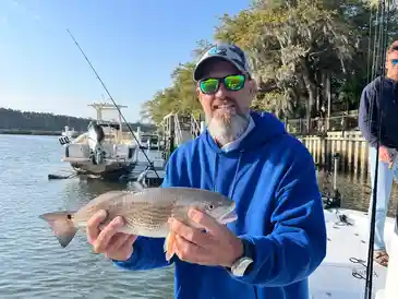 Man holding fish on a boat