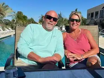 Man and woman sitting by poolside