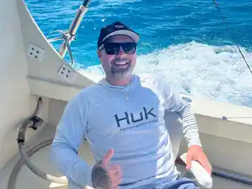 Happy man fishing at sea