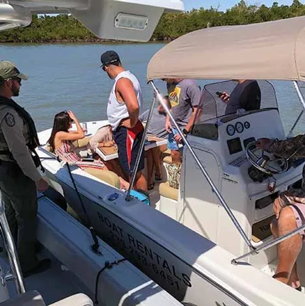 Group on rental boat near shoreline