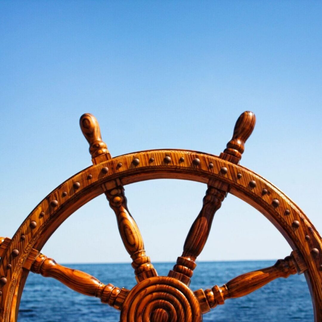 Ship's wheel with ocean background