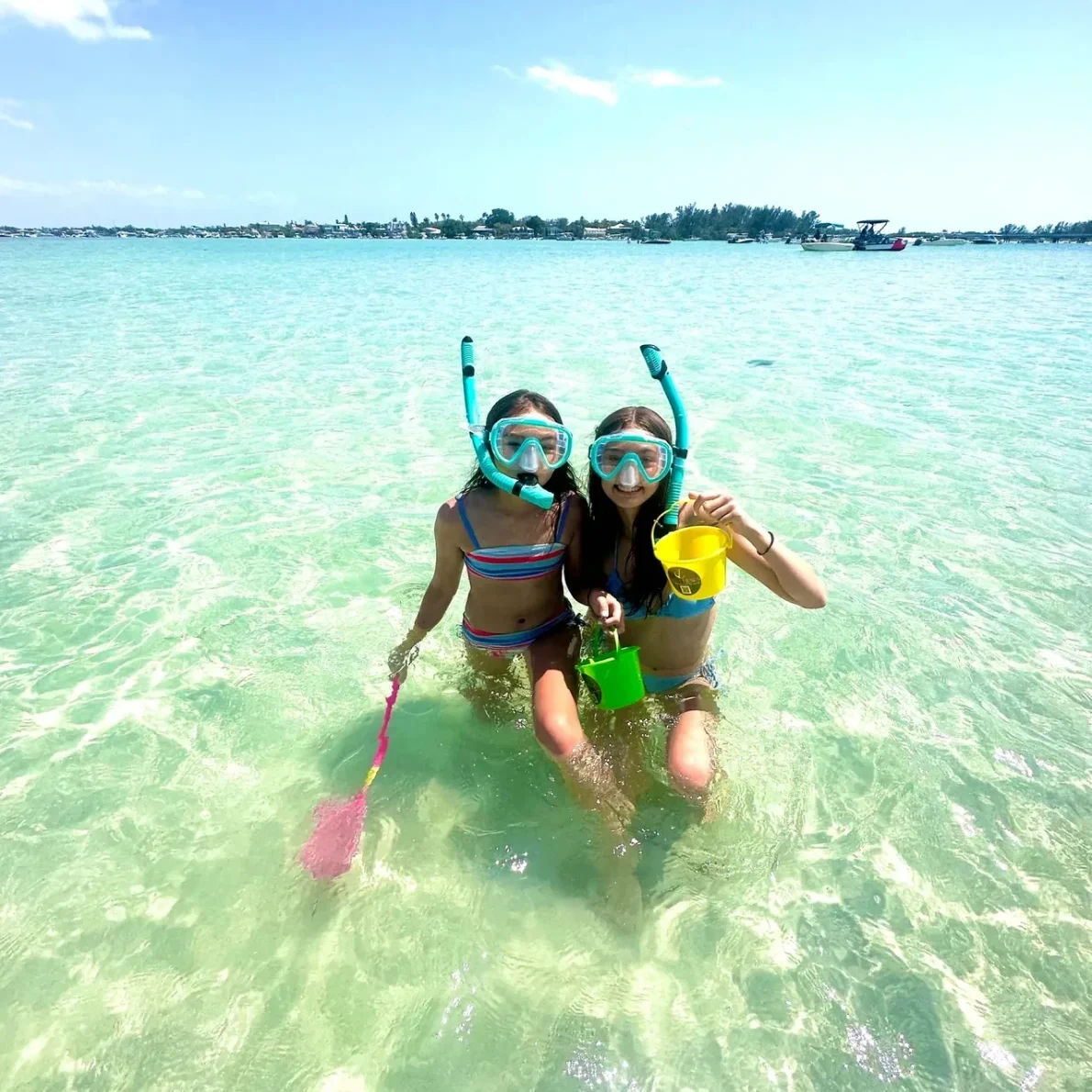 Friends snorkeling in shallow sea