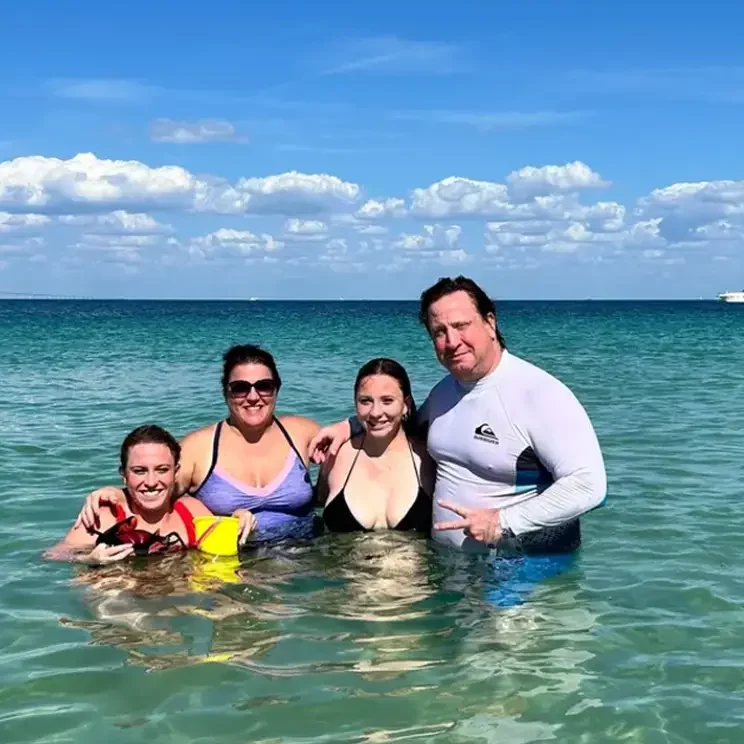 Group smiling in clear blue water