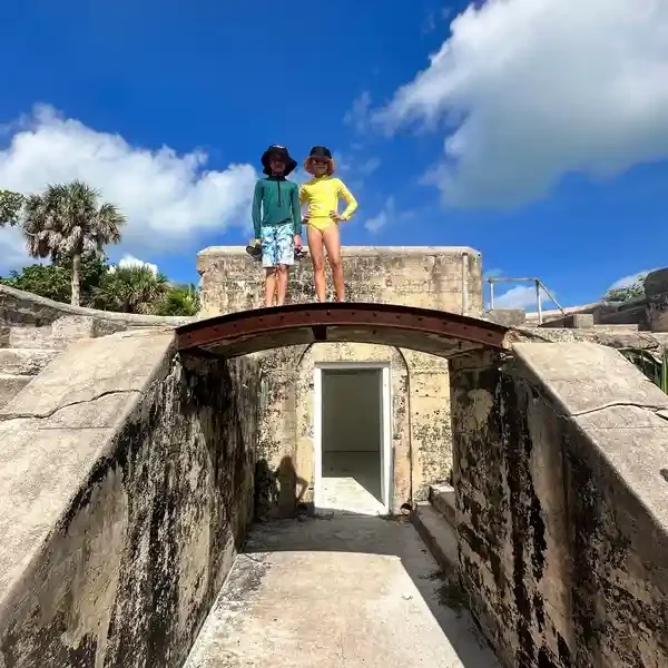 Two children atop ancient ruins bridge